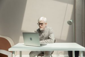 businessman working on laptop at table in office